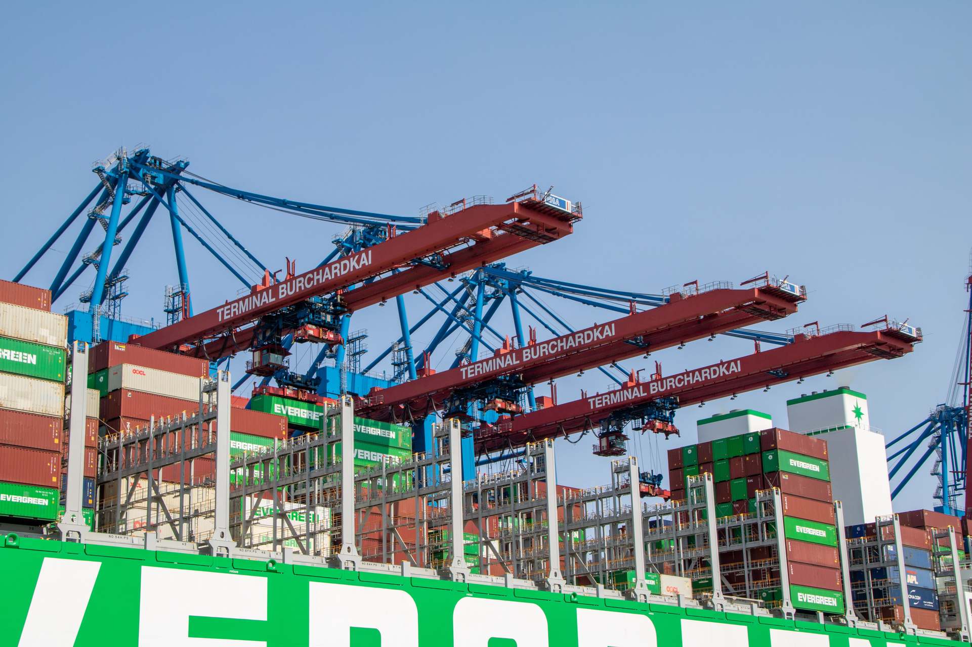 Containers at a terminal with cranes, cargo containers close-up